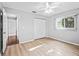 Bedroom featuring modern light-colored flooring, neutral walls, and a ceiling fan at 9757 Se 175Th Pl, Summerfield, FL 34491
