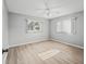 Bedroom boasting wood-look flooring, neutral walls, ceiling fan, and lots of natural light at 9757 Se 175Th Pl, Summerfield, FL 34491