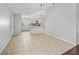 Open dining area featuring neutral tile floors, and a view of an updated kitchen with counter bar and cabinets at 9757 Se 175Th Pl, Summerfield, FL 34491