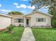 Close-up of the home's front entrance showing the sidewalk and the house's exterior with windows and green shutters at 9757 Se 175Th Pl, Summerfield, FL 34491