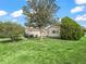 Beautiful single-Gathering home with mature trees accenting the front yard and walkway leading to the main entrance at 9757 Se 175Th Pl, Summerfield, FL 34491