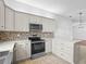 Kitchen boasts neutral colors, stone backsplash, stainless appliances, and ample counter space at 9757 Se 175Th Pl, Summerfield, FL 34491
