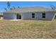 A flat backyard featuring a sliding glass door with a concrete patio at 15010 Sw 29Th Ave Road, Ocala, FL 34473