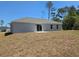 A flat backyard featuring a sliding glass door with a concrete patio at 15010 Sw 29Th Ave Road, Ocala, FL 34473