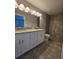Modern bathroom with dual vanity, granite counters, and tiled walk-in shower at 15010 Sw 29Th Ave Road, Ocala, FL 34473