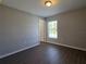 Comfortable bedroom with large window and luxury vinyl plank flooring at 15010 Sw 29Th Ave Road, Ocala, FL 34473