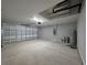 A spacious garage with an automatic door, utility closet, and a concrete floor at 15010 Sw 29Th Ave Road, Ocala, FL 34473