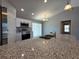 Open kitchen with granite countertops, stainless steel appliances, and a large island at 15010 Sw 29Th Ave Road, Ocala, FL 34473