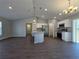 Open-concept kitchen boasts a large island, stainless steel appliances, and modern lighting at 15010 Sw 29Th Ave Road, Ocala, FL 34473