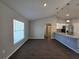 Bright living room featuring modern vinyl plank flooring and a view into the kitchen at 15010 Sw 29Th Ave Road, Ocala, FL 34473