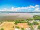 Beautiful aerial view highlighting the lakefront property, surrounding trees and open land at 1001 N Lakeshore Blvd, Howey In The Hills, FL 34737