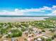 Beautiful aerial view of a neighborhood and lake, with lush greenery throughout the area at 1001 N Lakeshore Blvd, Howey In The Hills, FL 34737