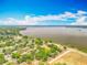 Expansive aerial view of a waterfront community, showcasing lake views and beautiful blue skies at 1001 N Lakeshore Blvd, Howey In The Hills, FL 34737