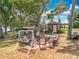 Scenic backyard setting with a gazebo, fire pit, seating area, and mature trees, ideal for outdoor living at 1001 N Lakeshore Blvd, Howey In The Hills, FL 34737