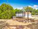 Backyard with a trampoline, mature trees, and an outdoor area, ideal for recreation and relaxation at 1001 N Lakeshore Blvd, Howey In The Hills, FL 34737