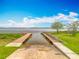 Scenic boat ramp leading into a serene lake, surrounded by lush greenery under a clear blue sky at 1001 N Lakeshore Blvd, Howey In The Hills, FL 34737