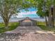 Scenic view of a wooden dock and gazebo extending over a tranquil lake, framed by lush greenery at 1001 N Lakeshore Blvd, Howey In The Hills, FL 34737