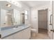 Clean bathroom with white vanity, walk-in shower, and access to a walk-in closet at 1212 Chaparral Dr, Lady Lake, FL 32159