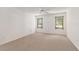 Bright bedroom with carpet flooring, ceiling fan, and large windows with natural light at 1212 Chaparral Dr, Lady Lake, FL 32159