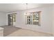 Open dining area with tiled floor and sliding door access to a lanai or patio at 1212 Chaparral Dr, Lady Lake, FL 32159