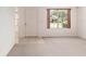 Bright entryway with tile and carpet flooring, a large window, and a white front door at 1212 Chaparral Dr, Lady Lake, FL 32159