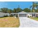 Charming single-story home with a well-maintained lawn, attached garage, and lush landscaping at 1212 Chaparral Dr, Lady Lake, FL 32159