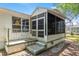 Side exterior view of the home with a porch, siding and an ADT security sign at 1212 Chaparral Dr, Lady Lake, FL 32159