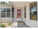 Exterior view of the charming front door and decorative windows at 1212 Chaparral Dr, Lady Lake, FL 32159