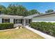Charming front entrance with lush landscaping and a well-manicured lawn at 1212 Chaparral Dr, Lady Lake, FL 32159