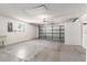 Spacious garage with an automatic door and windows, featuring epoxy flooring and ample storage at 1212 Chaparral Dr, Lady Lake, FL 32159