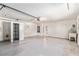 Garage interior featuring epoxy flooring, a utility sink, overhead lighting, and ample storage space at 1212 Chaparral Dr, Lady Lake, FL 32159