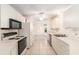Bright kitchen with white cabinets, tiled floor, and a black oven/stove range at 1212 Chaparral Dr, Lady Lake, FL 32159
