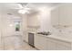 Bright kitchen with white cabinets, stainless steel appliances, and tile flooring at 1212 Chaparral Dr, Lady Lake, FL 32159