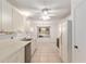 Bright and airy kitchen with white cabinetry, stainless sink, and tile flooring at 1212 Chaparral Dr, Lady Lake, FL 32159