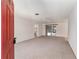 Bright, open living room featuring neutral carpet, ceiling fan, and access to the backyard at 1212 Chaparral Dr, Lady Lake, FL 32159
