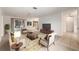 Open-concept living room with a ceiling fan and views of the lanai at 1212 Chaparral Dr, Lady Lake, FL 32159