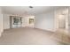 Spacious living room featuring neutral carpet, ceiling fan, and natural light at 1212 Chaparral Dr, Lady Lake, FL 32159