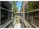 An exterior view of the porch with a white railing leading to the lawn at 1212 Chaparral Dr, Lady Lake, FL 32159