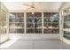 A view of the screened in porch featuring a ceiling fan and outside views at 1212 Chaparral Dr, Lady Lake, FL 32159