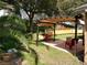Backyard patio with pergola, lawn and built-in seating at 1307 Rain Forest Ln, Minneola, FL 34715