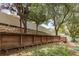 Wood fence with built-in benches and fire pit in backyard at 1307 Rain Forest Ln, Minneola, FL 34715