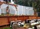 Outdoor entertaining space featuring custom wood seating with tables at 1307 Rain Forest Ln, Minneola, FL 34715