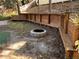 Backyard with custom wood built-in seating and fire pit at 1307 Rain Forest Ln, Minneola, FL 34715