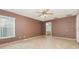 Neutral bedroom featuring a ceiling fan and a connecting door to the bathroom at 1307 Rain Forest Ln, Minneola, FL 34715