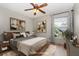 Staged bedroom with neutral decor and an exterior view at 1307 Rain Forest Ln, Minneola, FL 34715