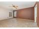 Empty bedroom featuring a ceiling fan, large windows, tile floors, freshly painted walls, and minimal decor at 1307 Rain Forest Ln, Minneola, FL 34715