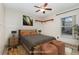 Bedroom with a bed, nightstands, and a window for natural light at 1307 Rain Forest Ln, Minneola, FL 34715