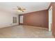 Empty bedroom with tiled floor, a ceiling fan, and two windows at 1307 Rain Forest Ln, Minneola, FL 34715