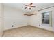 Unfurnished bedroom featuring neutral walls, tile floors, and natural light at 1307 Rain Forest Ln, Minneola, FL 34715
