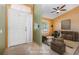 Inviting entryway with tile flooring leading to a cozy living area with a comfortable couch and stylish decor at 1307 Rain Forest Ln, Minneola, FL 34715